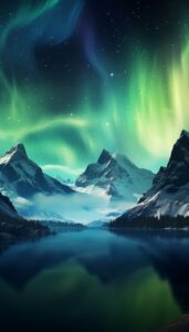 Ice-capped mountains under a night sky displaying a vibrant aurora borealis, with the northern lights reflecting on a calm lake, available as iPhone wallpaper.