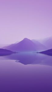 Layered purple mountains and a serene lake under a gradient violet sky, ideal for an iPhone wallpaper or phone background.